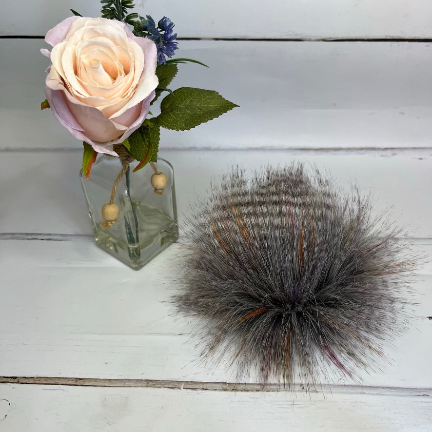 Sunburst coloured faux fur pom pom. Detachable option. Handmade