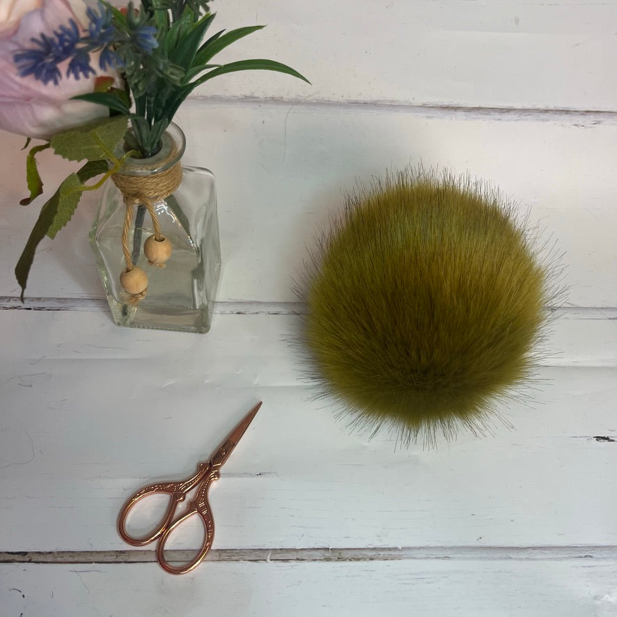 Lime coloured faux fur pom pom