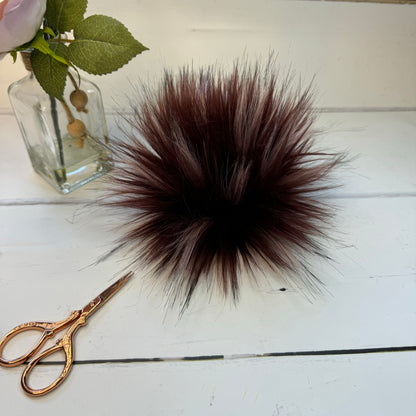 Redwood coloured faux fur pom pom. Detachable option. Handmade