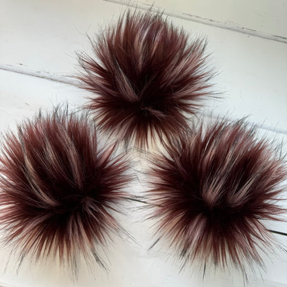 Redwood coloured faux fur pom pom. Detachable option. Handmade