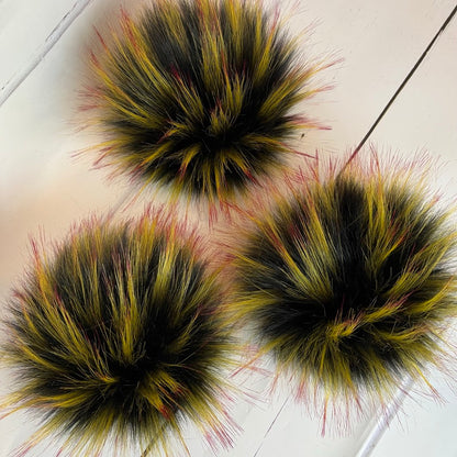 Mockingjay coloured faux fur pom pom - a black with yellow and red tips. Detachable option
